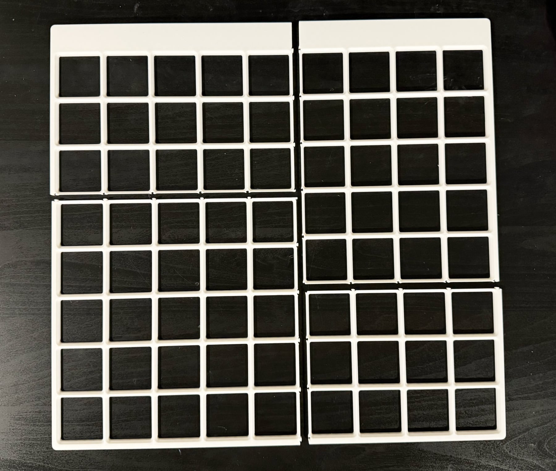 Printed baseplate in matte white PLA shown on desktop as four separate pieces that snap together.